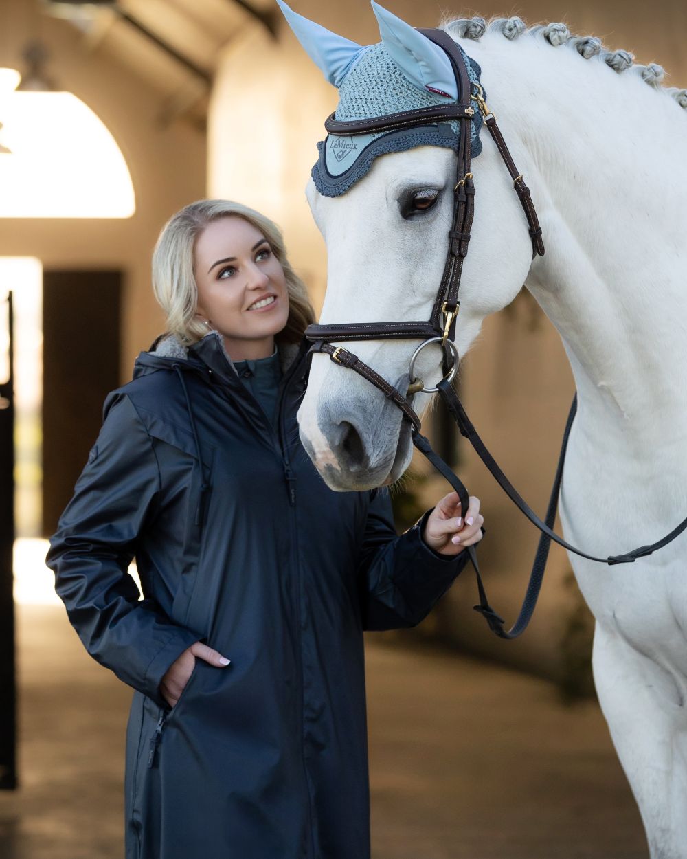 Navy Coloured LeMieux Elements Coat On A Stable Background 