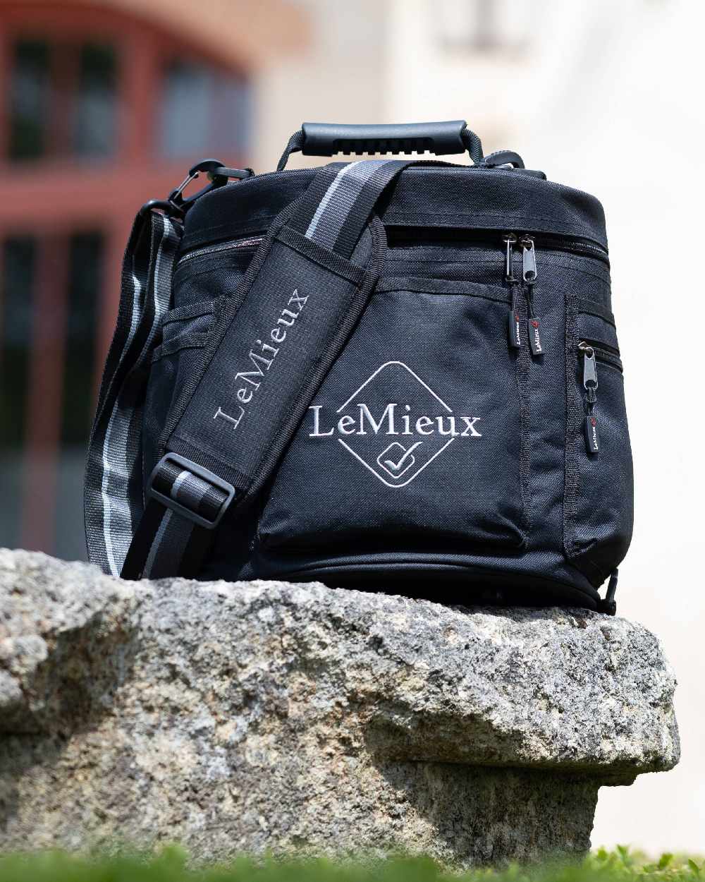 Black coloured LeMieux Elite Circular Grooming Tote on rock background 