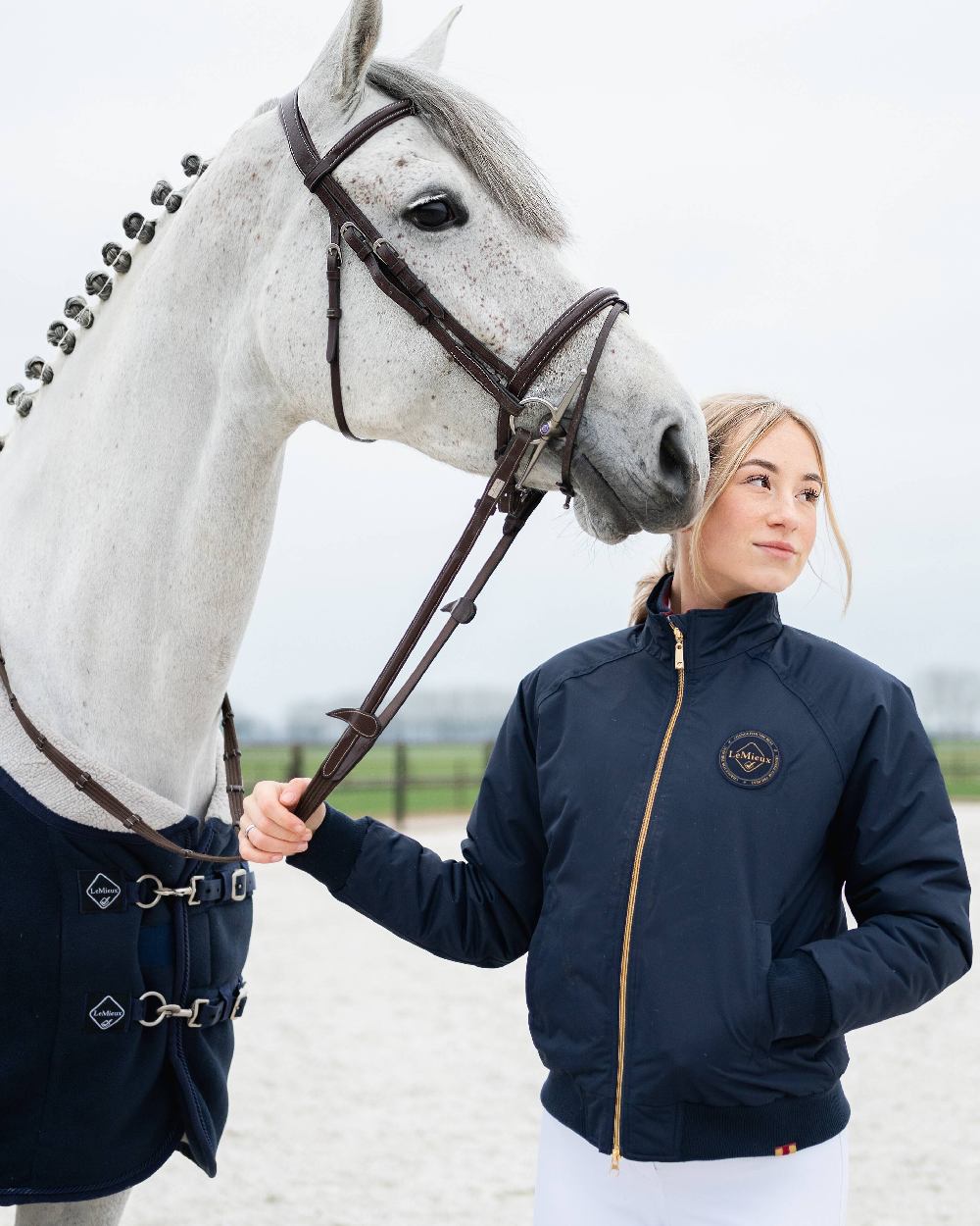 Navy coloured LeMieux Elite Crew Jacket on sky background 