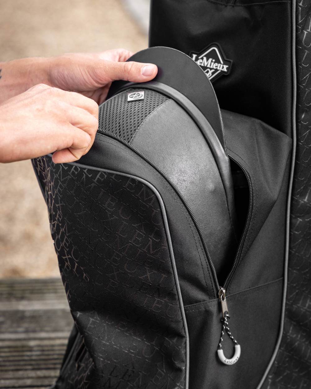 Black coloured LeMieux Elite Pro Boot &amp; Hat Bag on blurry background 