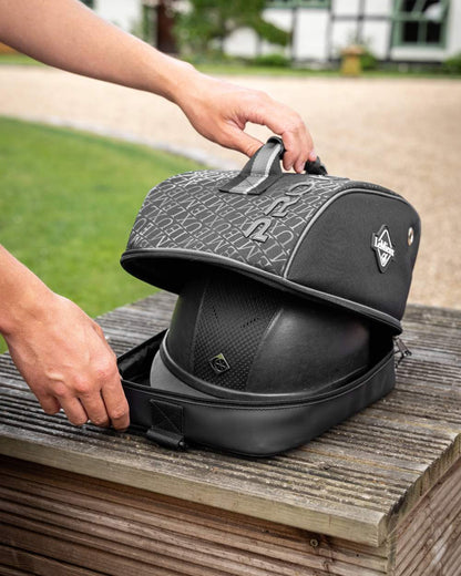 Black coloured LeMieux Elite Pro Hat Box on wooden background 