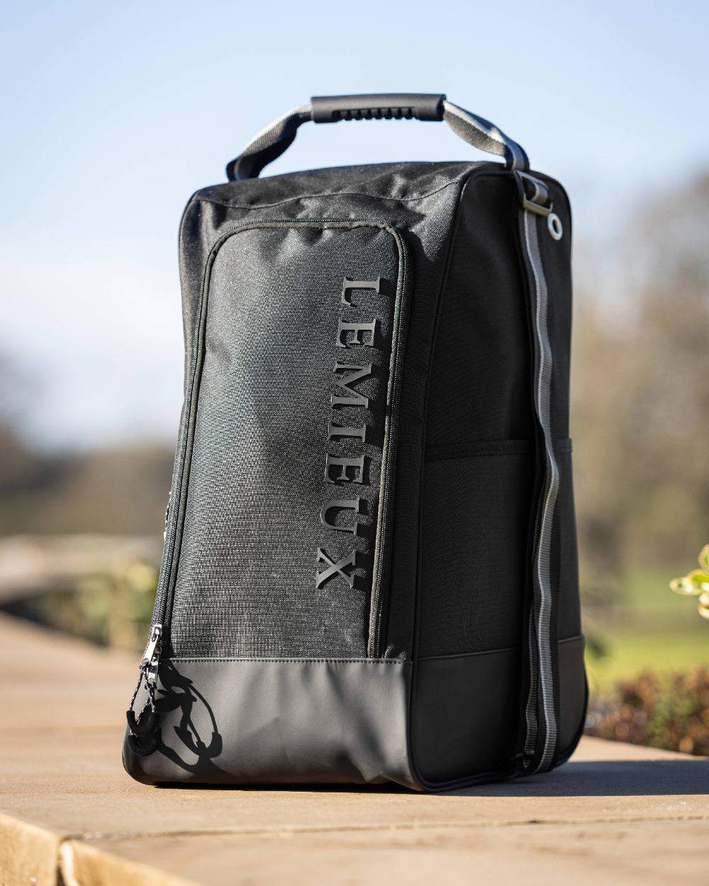 Black coloured LeMieux Elite Wellington Boot Bag on blurry background 