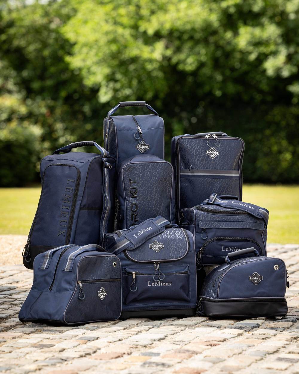Navy coloured LeMieux Elite Wellington Boot Bag with tress in background 