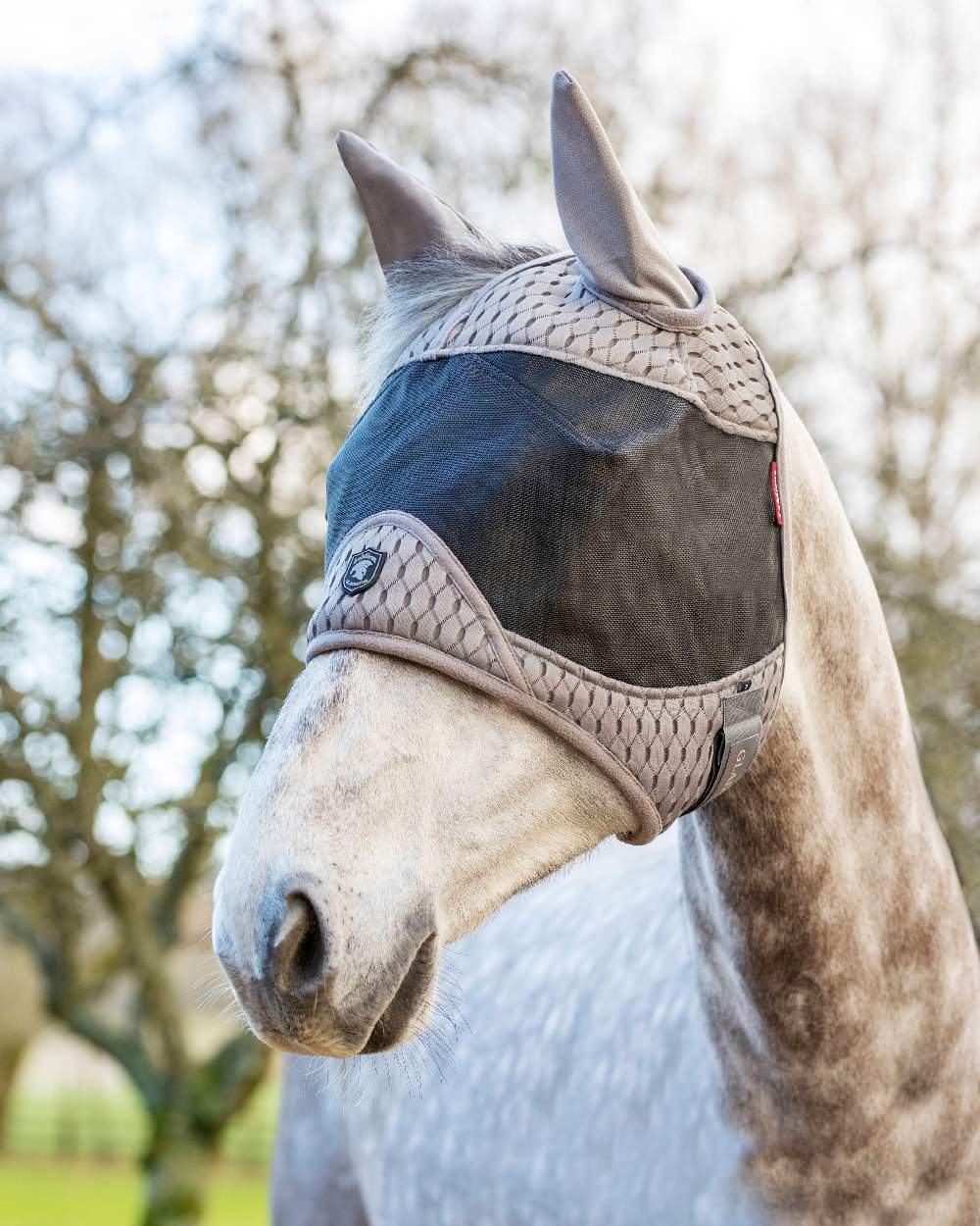 Grey coloured LeMieux Gladiator Half Fly Mask on sky background 