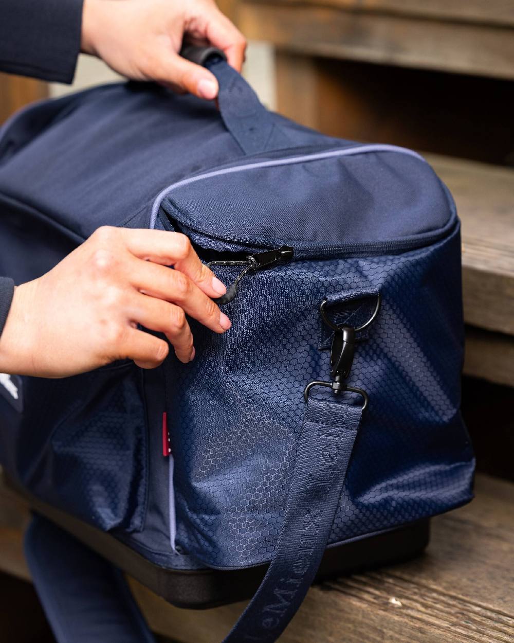 Navy coloured LeMieux Grooming Kit Pro on blurry background 