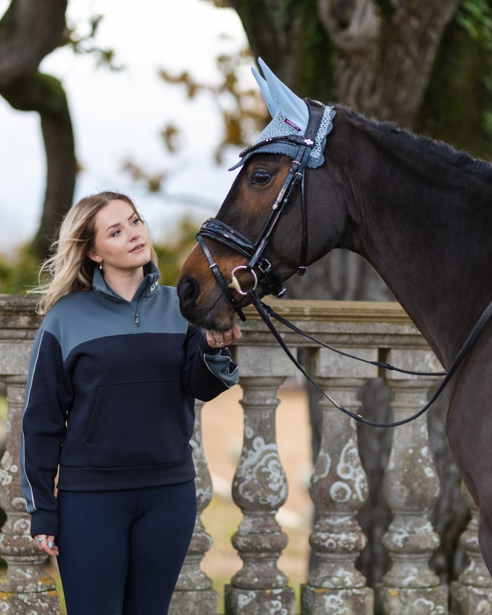 Navy Petrol Coloured LeMieux Kali Quarter Zip Sweat On A Stable Background 