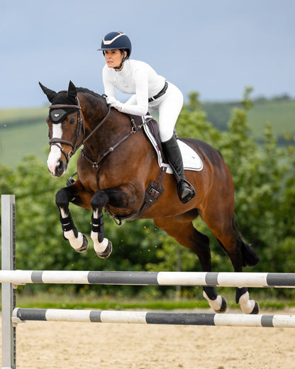 White Coloured LeMieux Loire Close Contact Square On A Riding Arena Background 