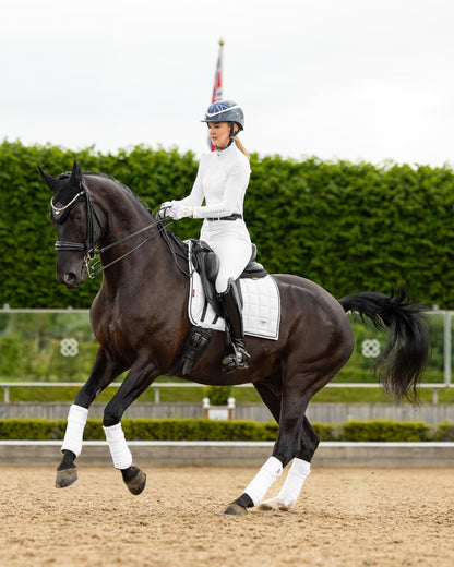 White Coloured LeMieux Loire Dressage Square On A Riding Arena Background 