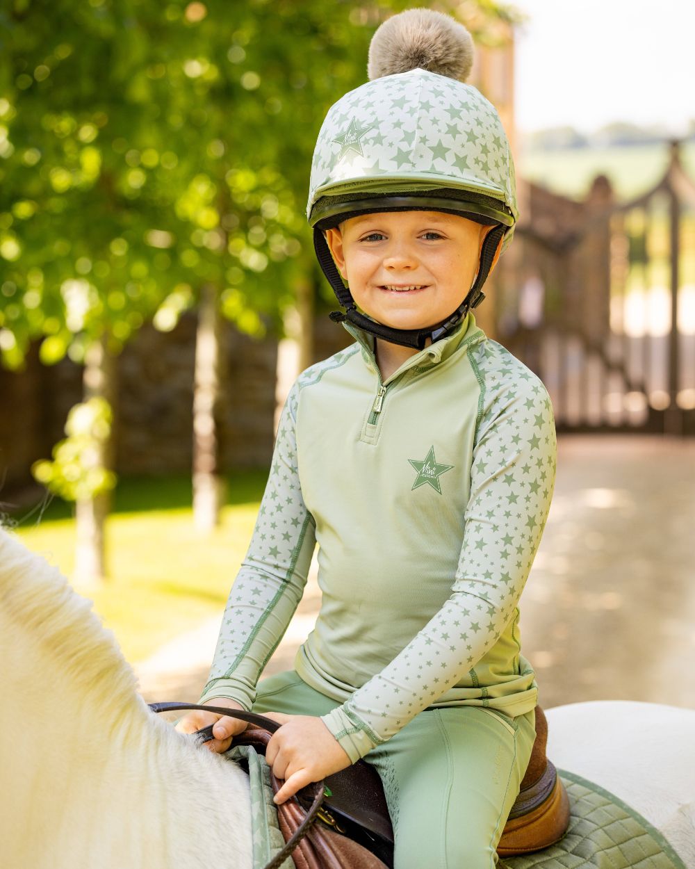 Fern coloured LeMieux Mini Base Layers on blurry green background 