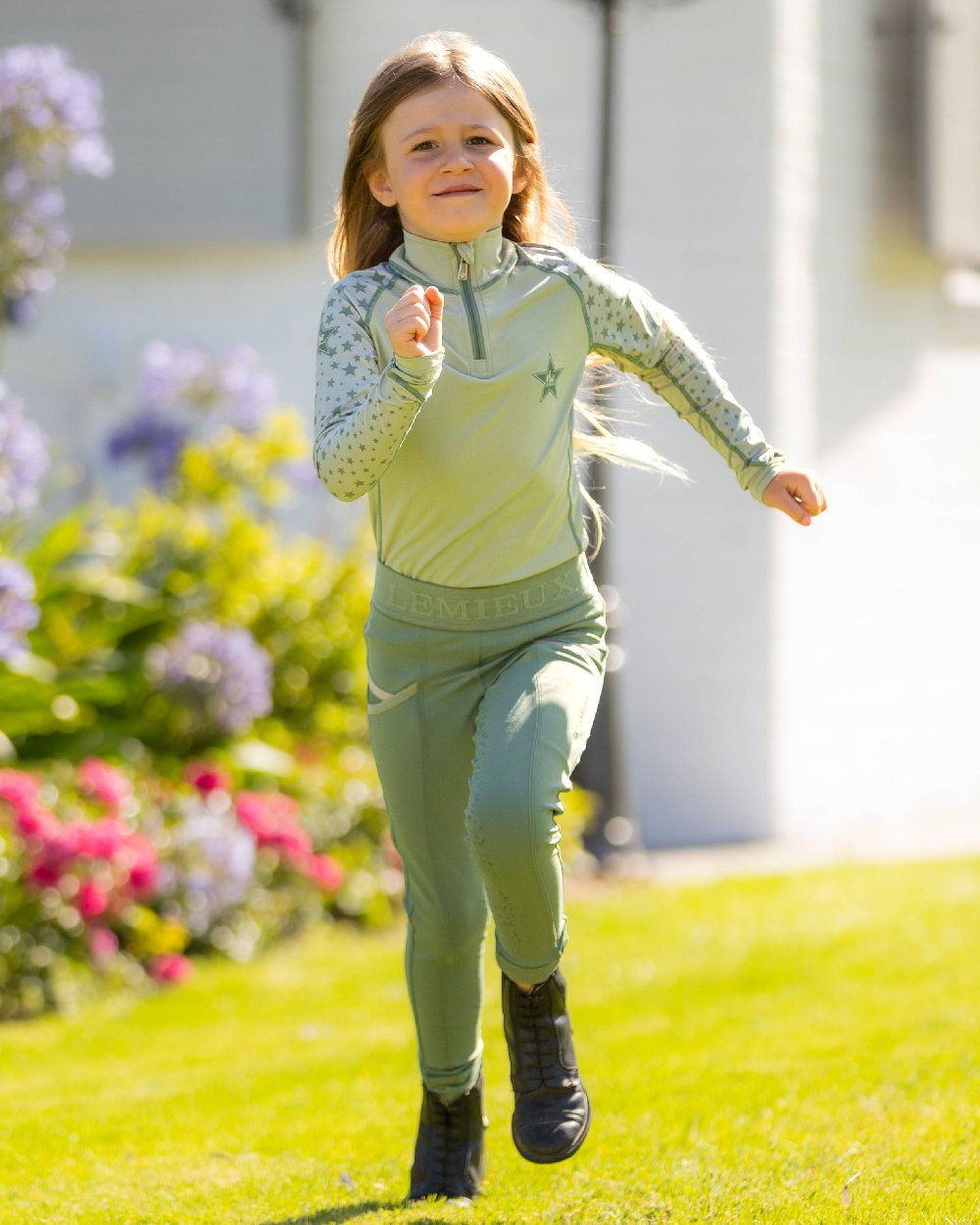 Fern coloured LeMieux Mini Base Layers on blurry green background 