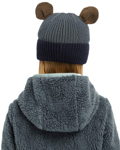 Petrol Coloured LeMieux Mini Bear Beanie On A Street Background 