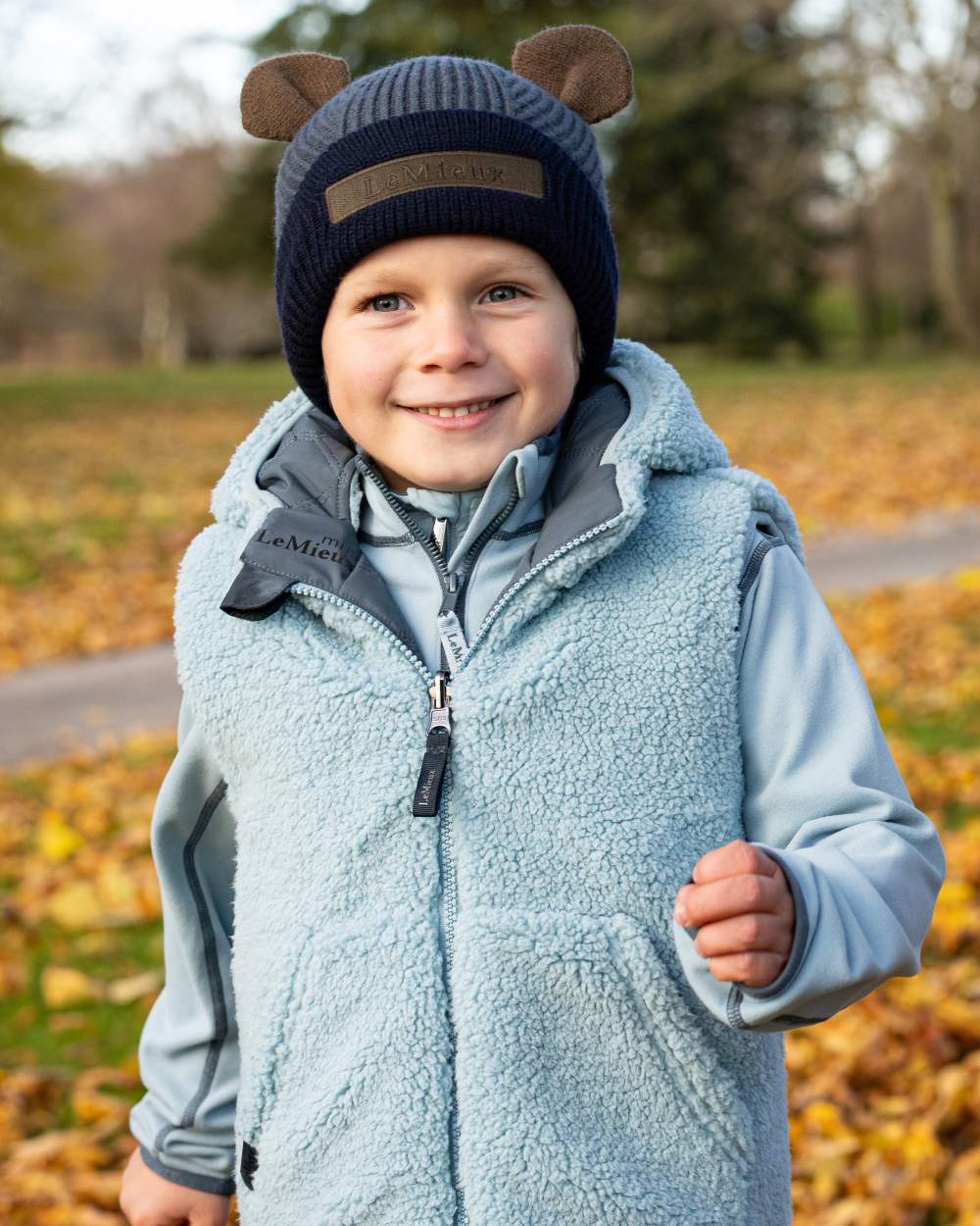 Petrol Coloured LeMieux Mini Bear Beanie On A Street Background 