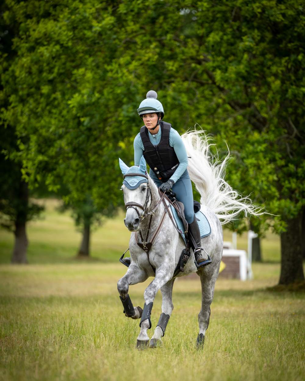 Glacier Coloured LeMieux Pippa Hat Silk On A Park Background 