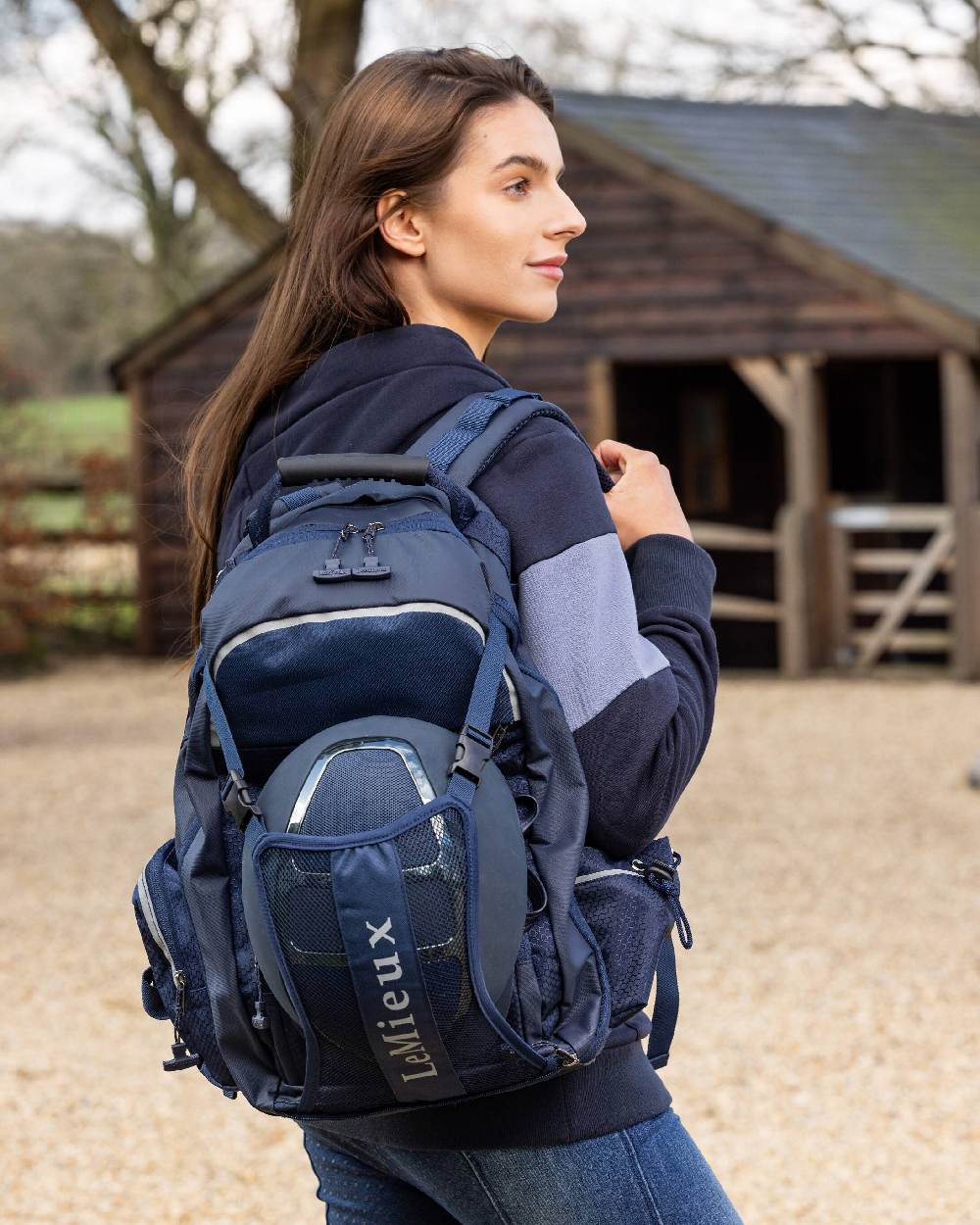 Navy coloured LeMieux Pro Rucksack on blurry stable background 