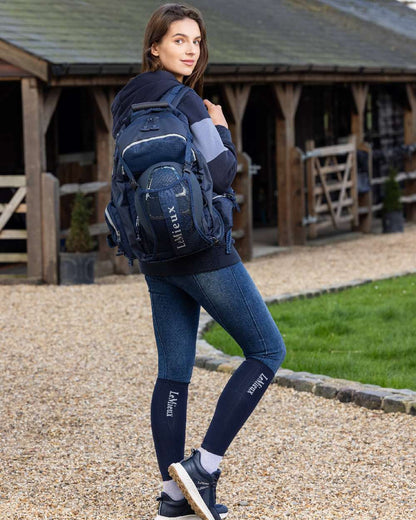 Navy coloured LeMieux Pro Rucksack with stable in background 
