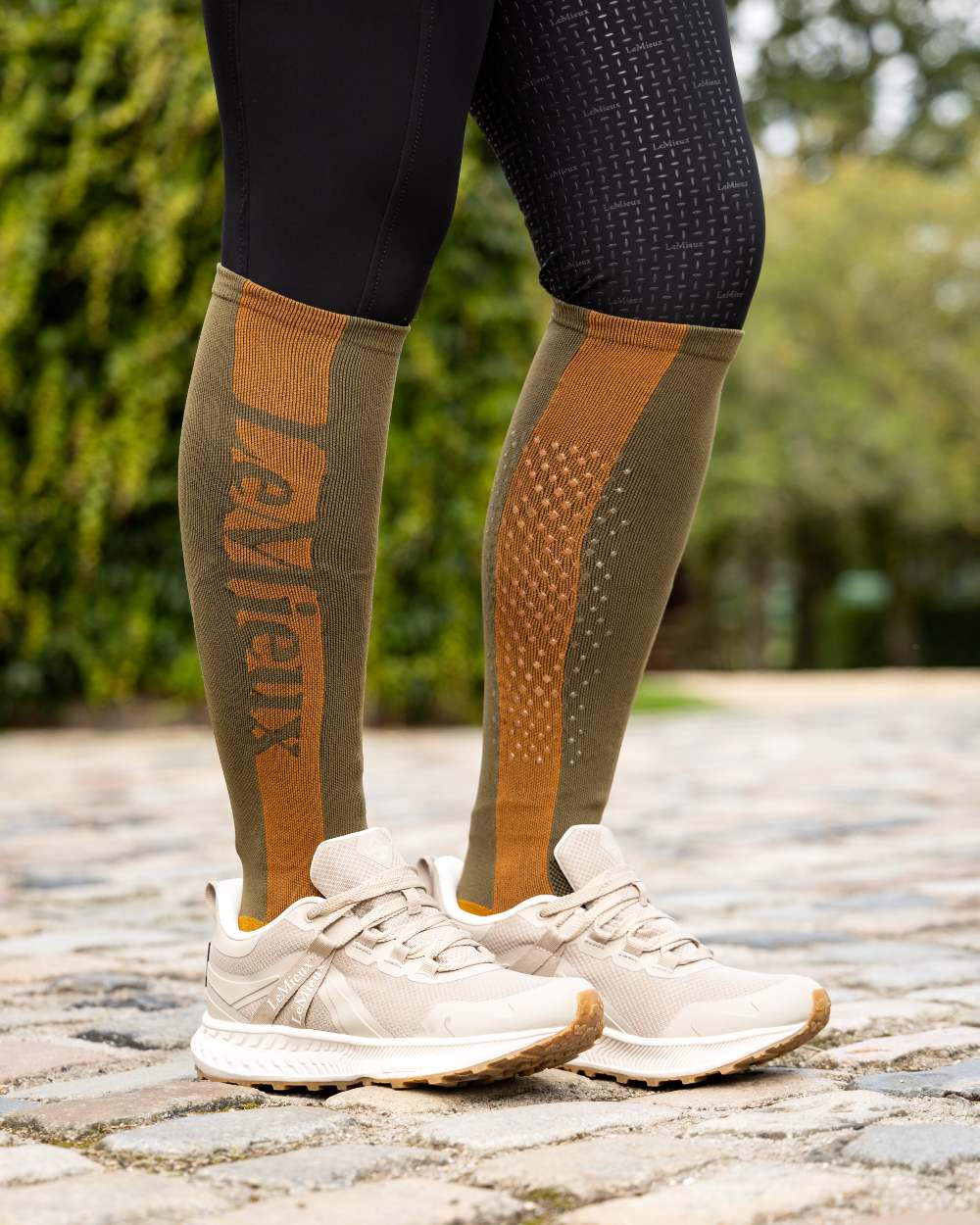 Alpine Coloured LeMieux Silicone Socks On A Street Background 