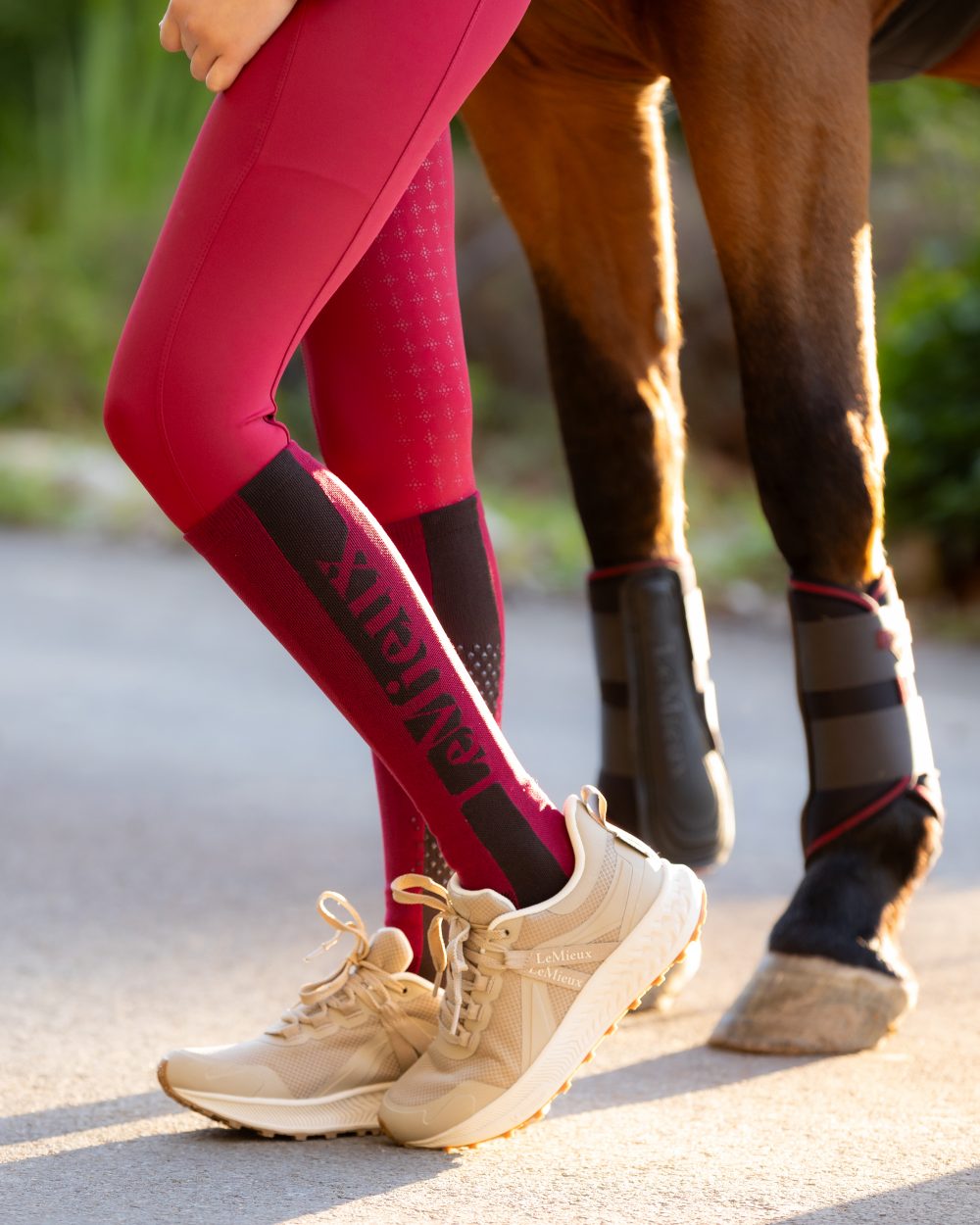 Ember Coloured LeMieux Silicone Socks On A Street Background 