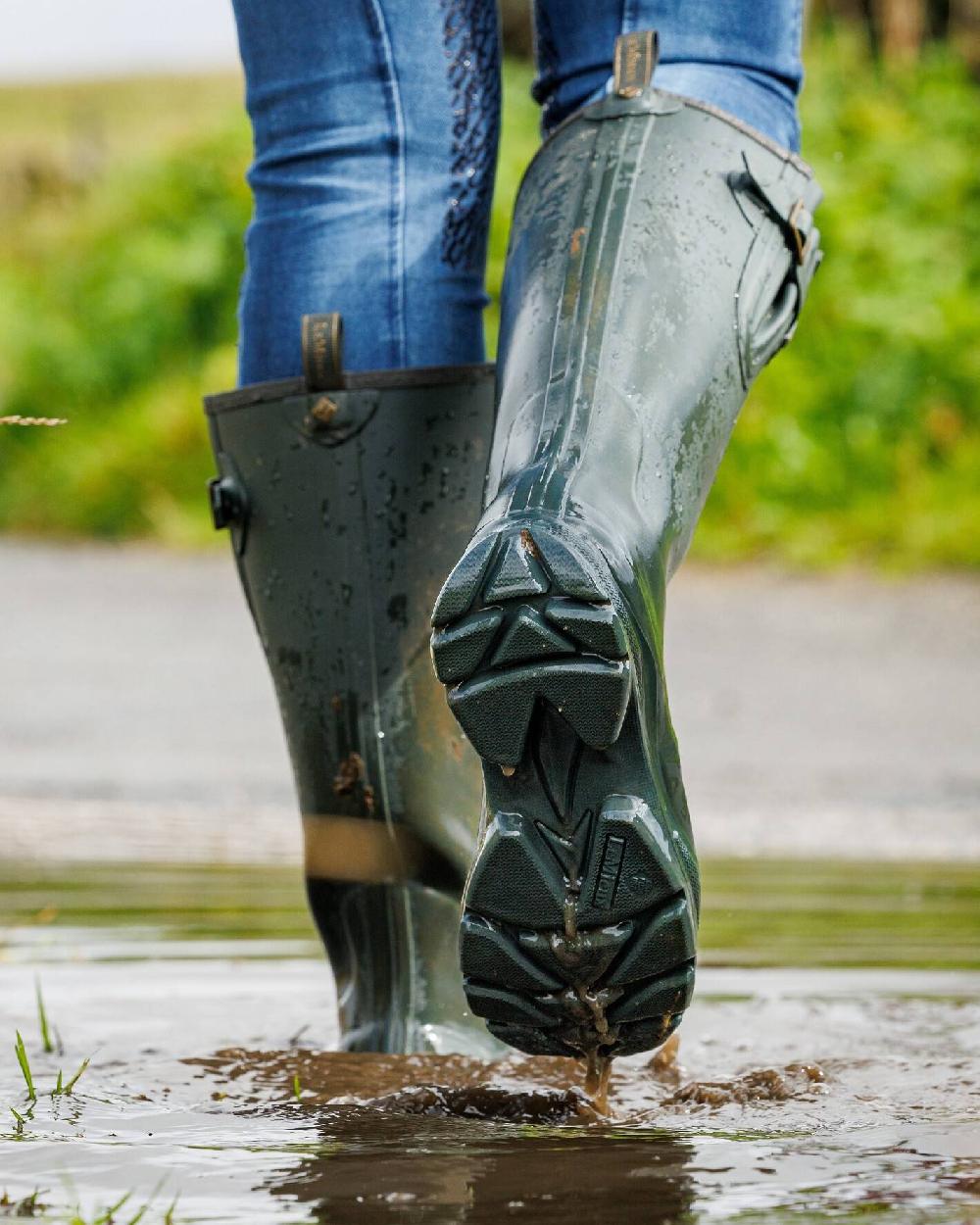 Oak coloured LeMieux Stride Wellington Boots on water background 