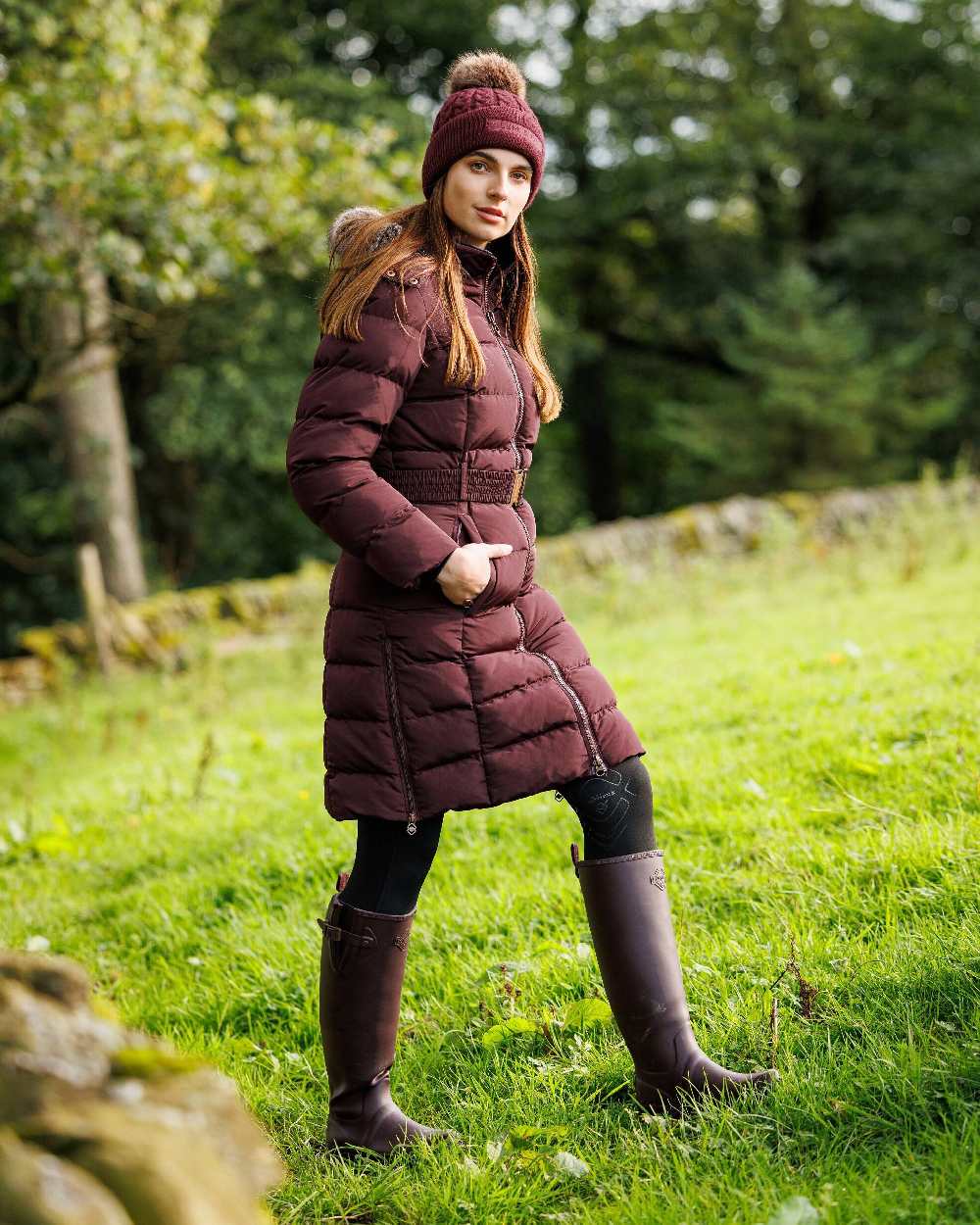 Port coloured LeMieux Stride Wellington Boots on grassy background 