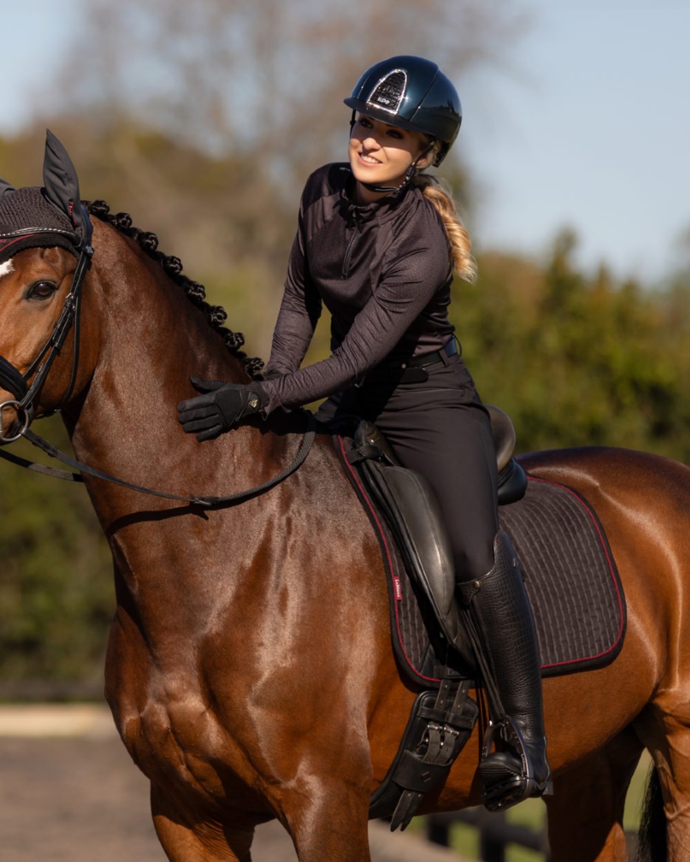 Cinder Coloured LeMieux Suede Dressage Square On A blurry Background 