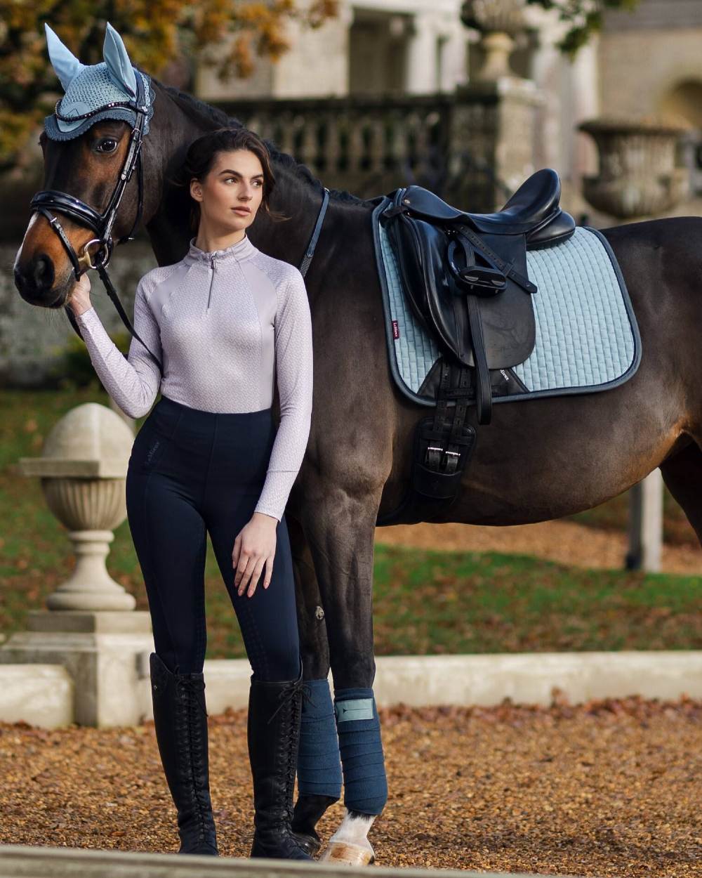 Glacier Coloured LeMieux Suede Dressage Square On A blurry Background 