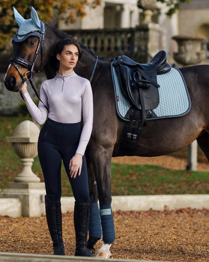 Glacier Coloured LeMieux Suede Dressage Square On A blurry Background 