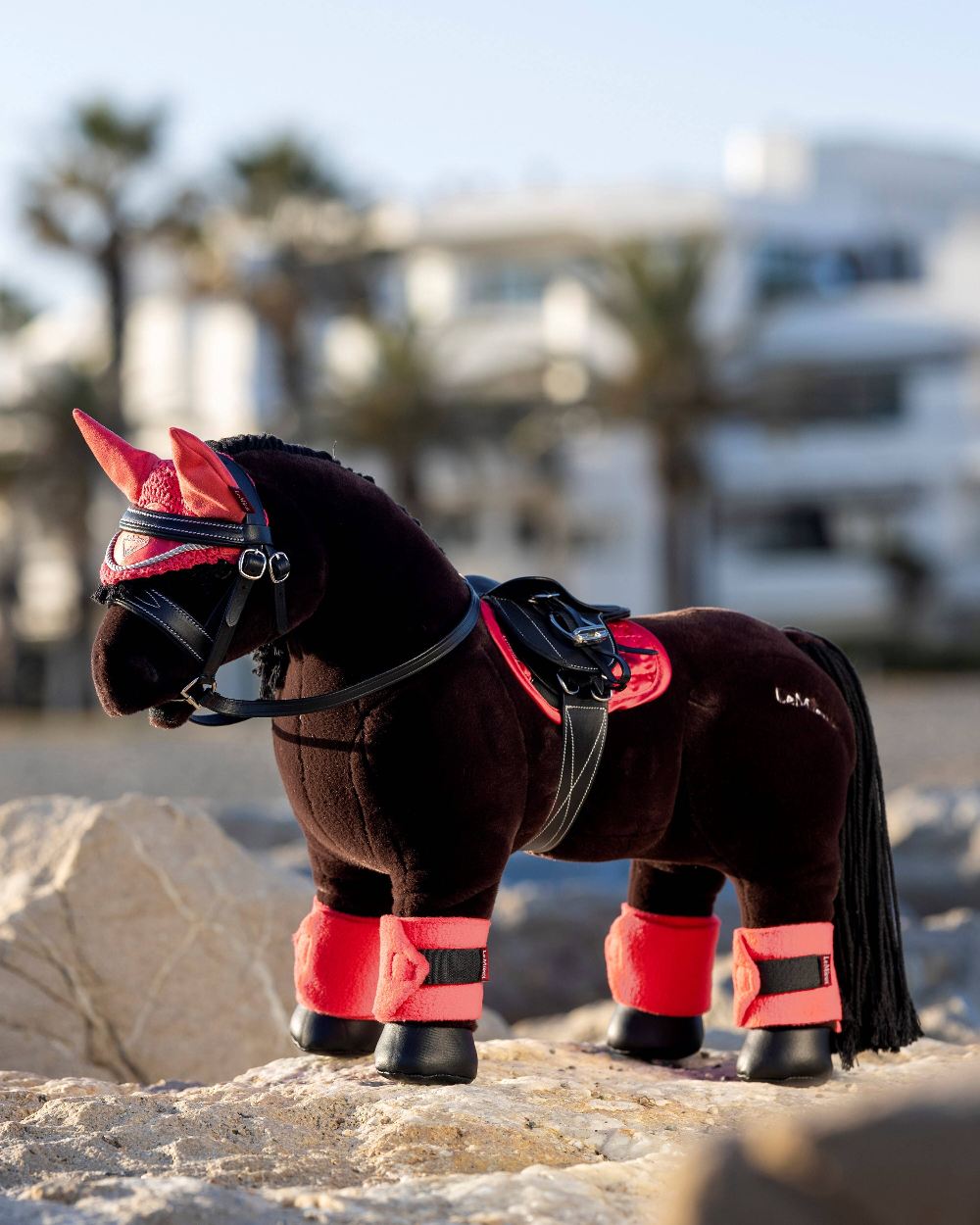 Papaya coloured LeMieux Toy Pony Bandages on blurry background 