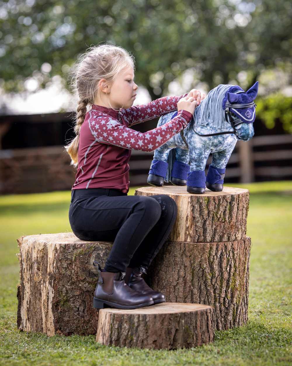 Black coloured LeMieux Toy Pony Bridle on blurred green background 