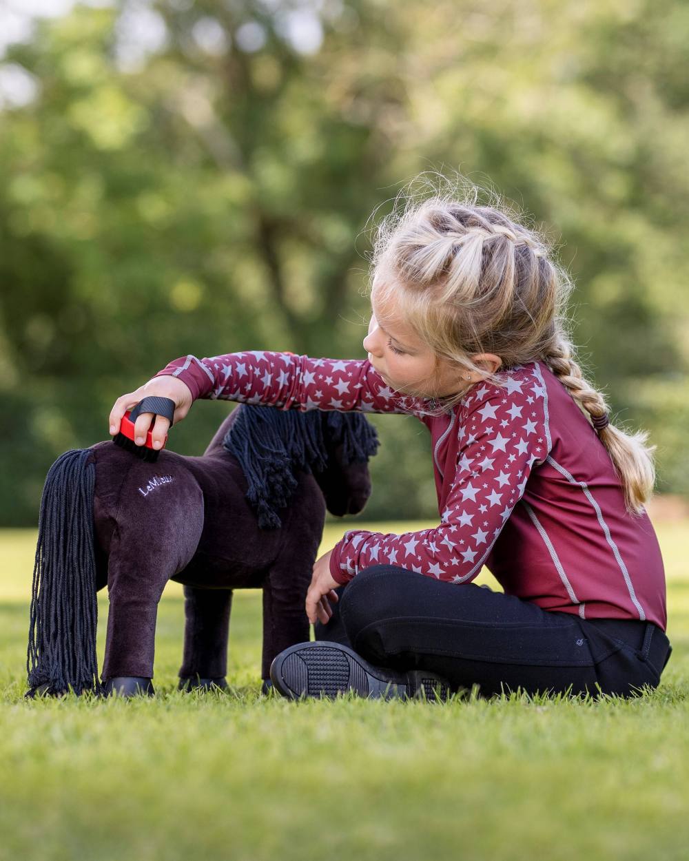 Ember Coloured LeMieux Toy Pony Grooming Kit On A Outer Yard Background 