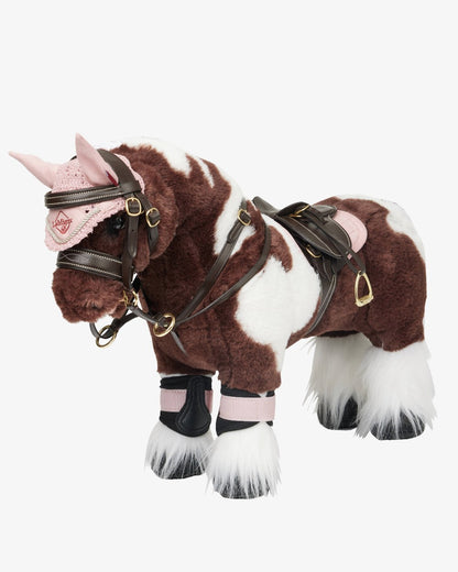 Brown coloured LeMieux Toy Pony Saddle on grey background 