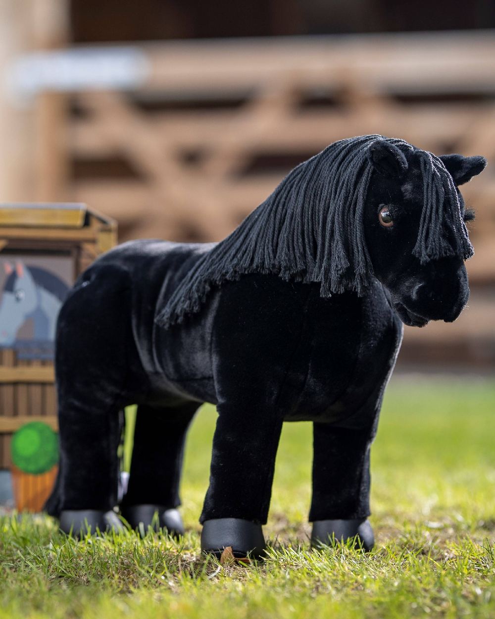 LeMieux Toy Pony Skye on blurry fence background 