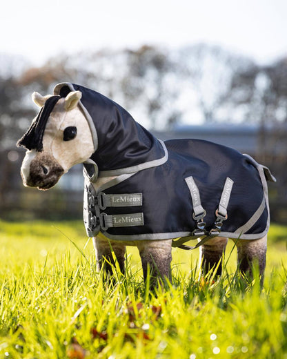 Navy coloured LeMieux Toy Pony Storm-Tek Rug on grassy background 