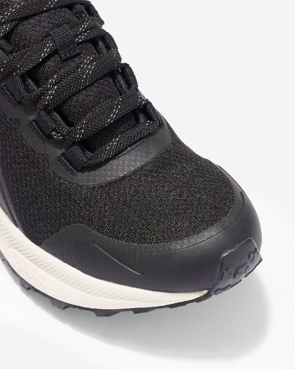 Black coloured LeMieux Trax Waterproof Trainers on grey background 