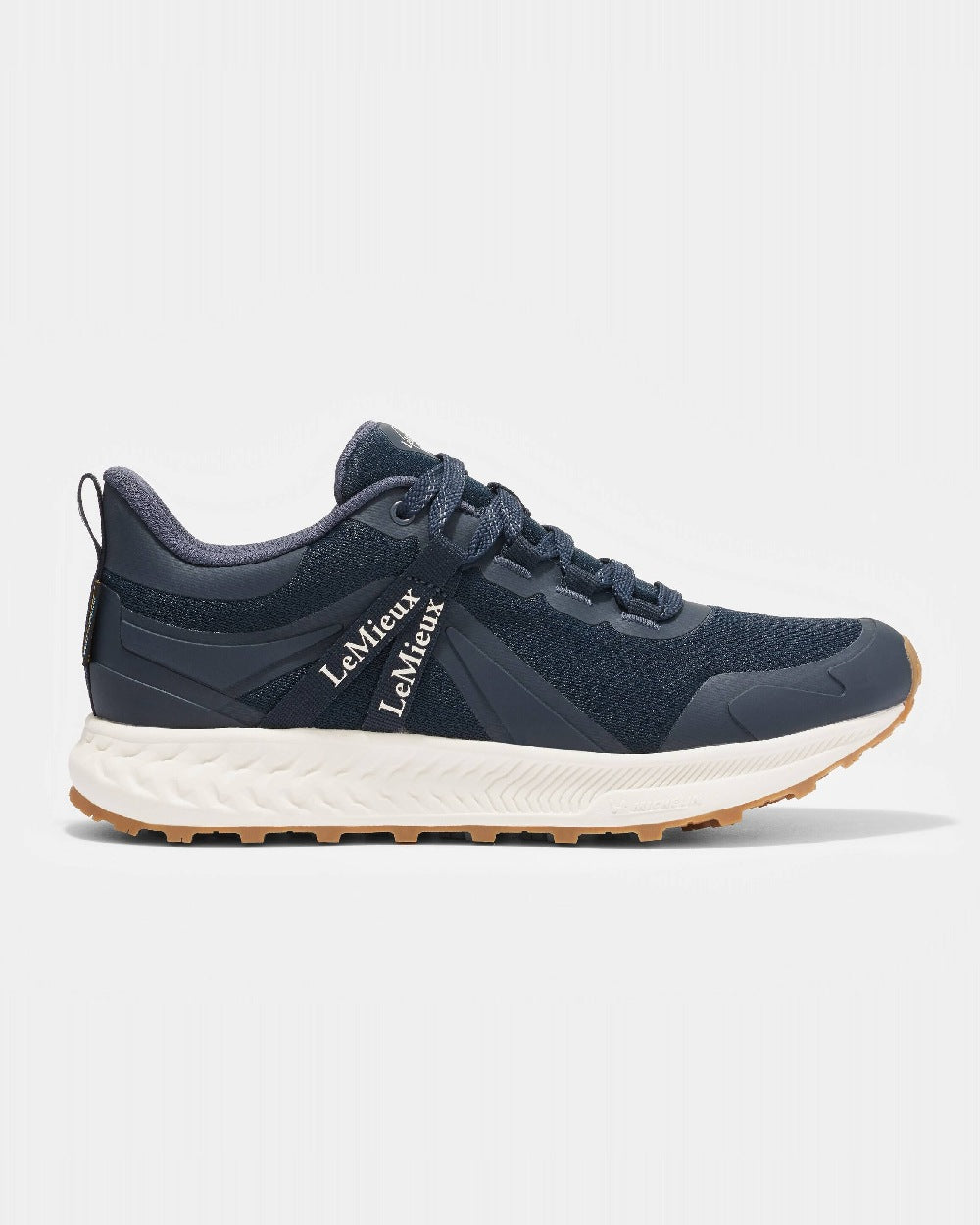 Navy coloured LeMieux Trax Waterproof Trainers on grey background 