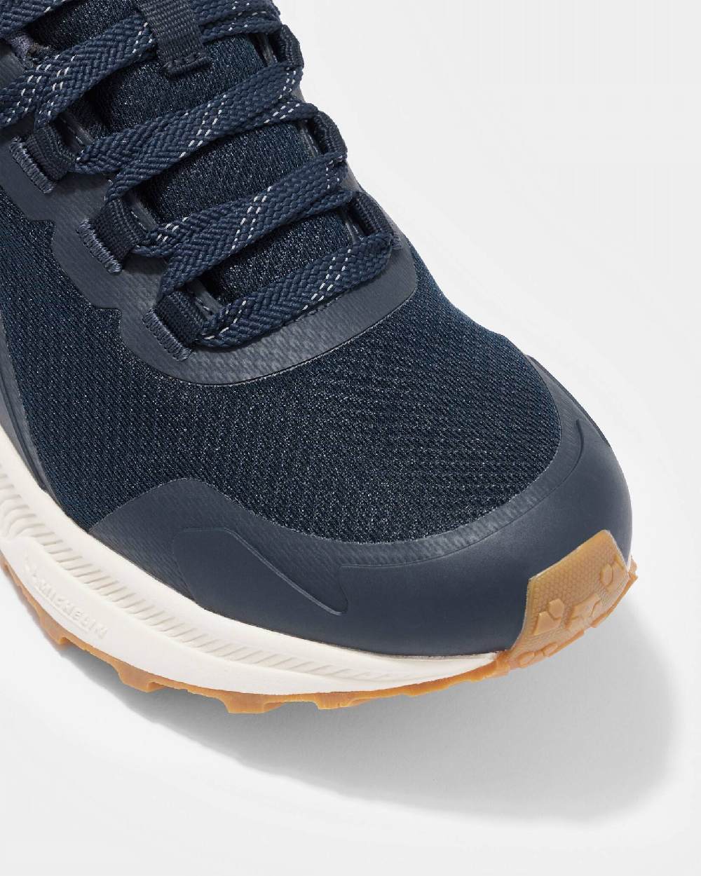 Navy coloured LeMieux Trax Waterproof Trainers on grey background 