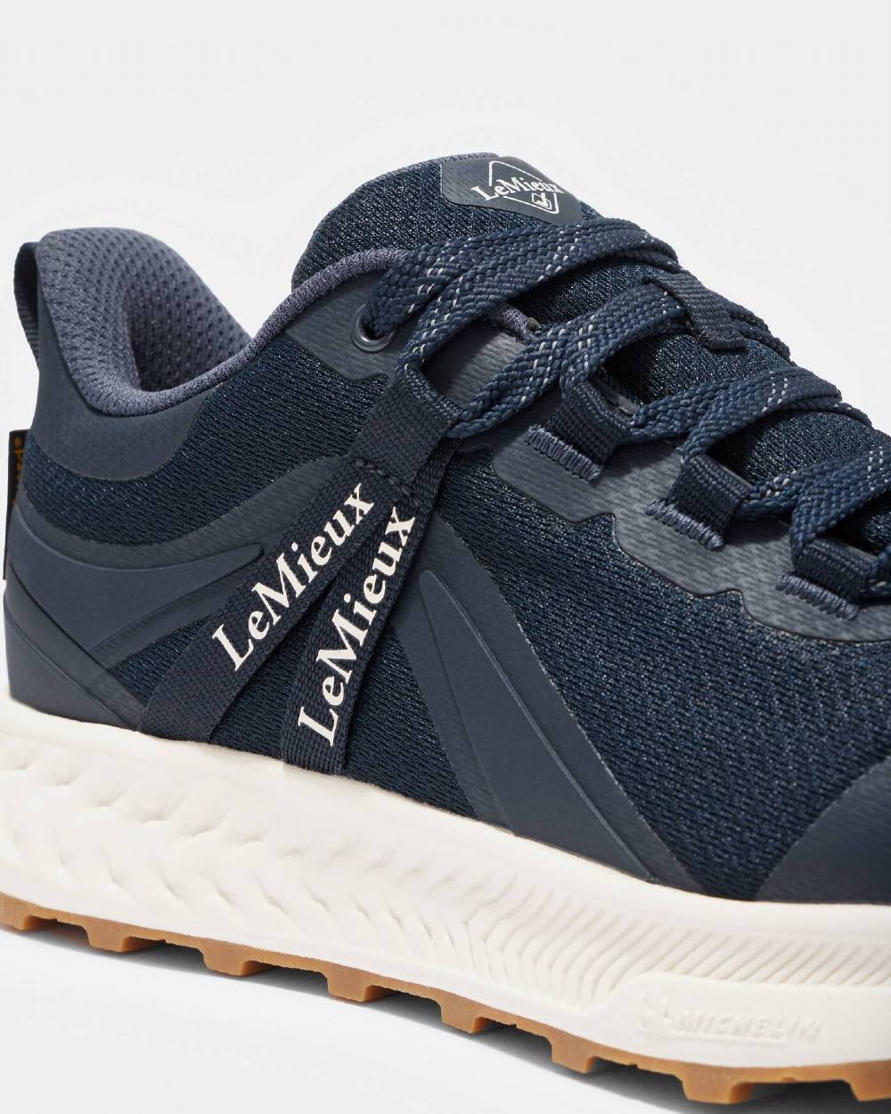 Navy coloured LeMieux Trax Waterproof Trainers on grey background 