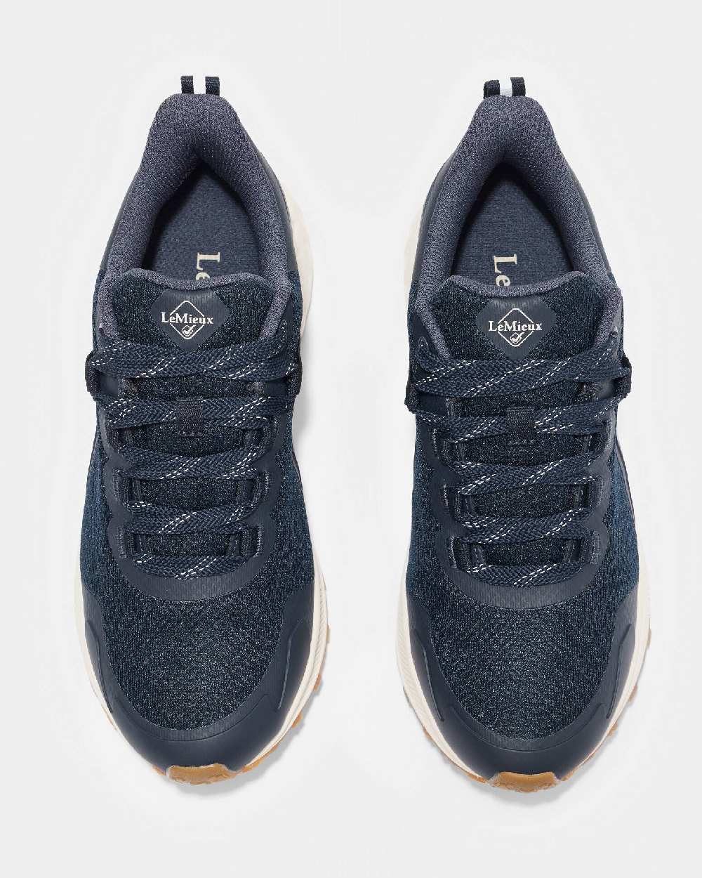 Navy coloured LeMieux Trax Waterproof Trainers on grey background 