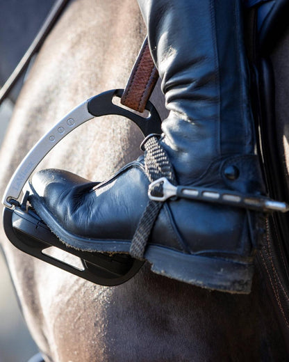 Black/Aluminium coloured LeMieux Vector Balance Stirrup on horse background 