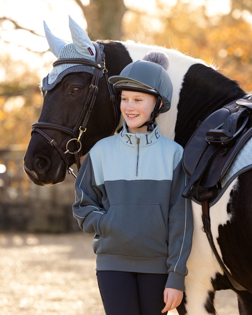 Petrol Glacier Coloured LeMieux Young Rider Kate Quarter Zip Sweater On A Outer Yard Background 