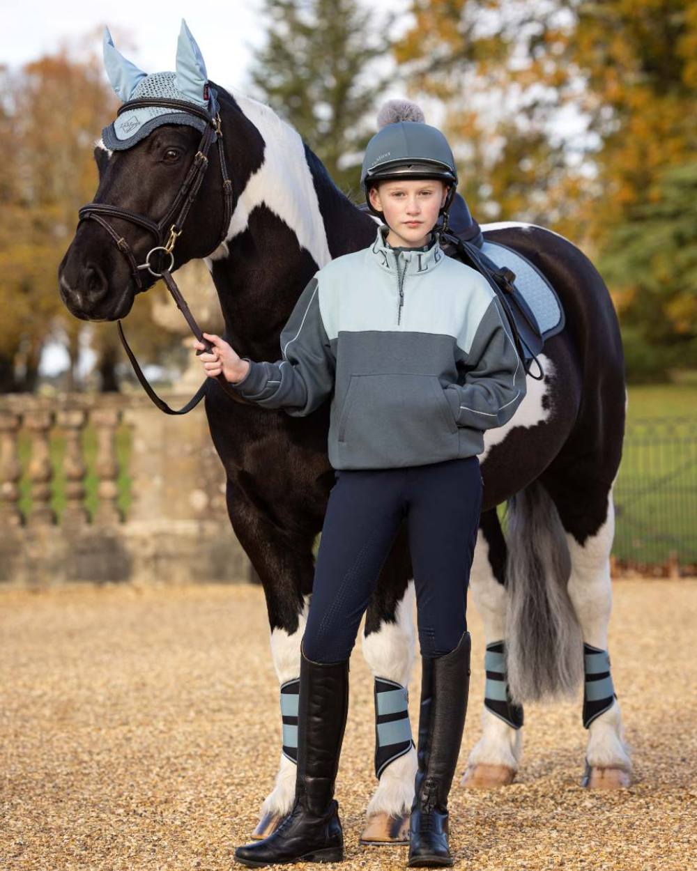 Petrol Glacier Coloured LeMieux Young Rider Kate Quarter Zip Sweater On A Outer Yard Background 