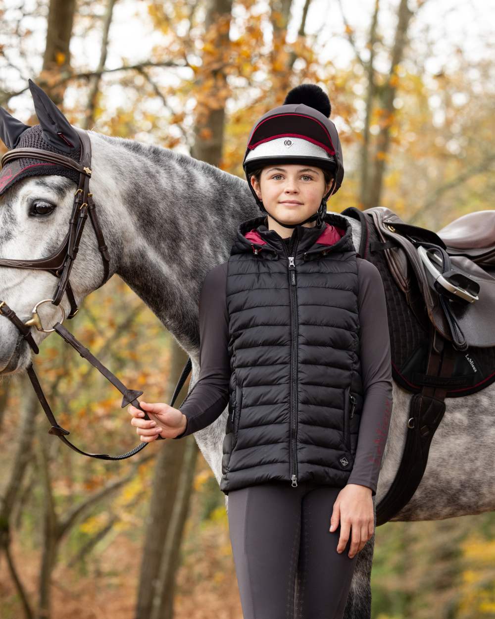 Black Coloured LeMieux Young Rider Milly Puffer Gilet On A Forest Background 