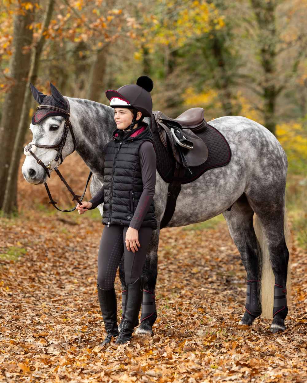 Black Coloured LeMieux Young Rider Milly Puffer Gilet On A Forest Background 