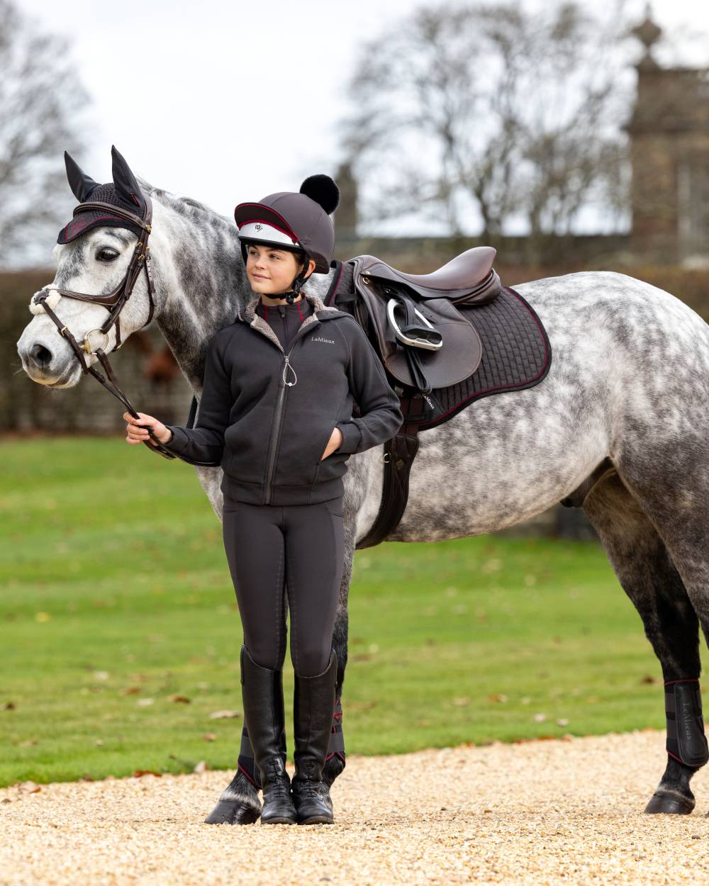 Cinder Coloured LeMieux Young Rider Orla Pull Ons On A Outer Yard Background 