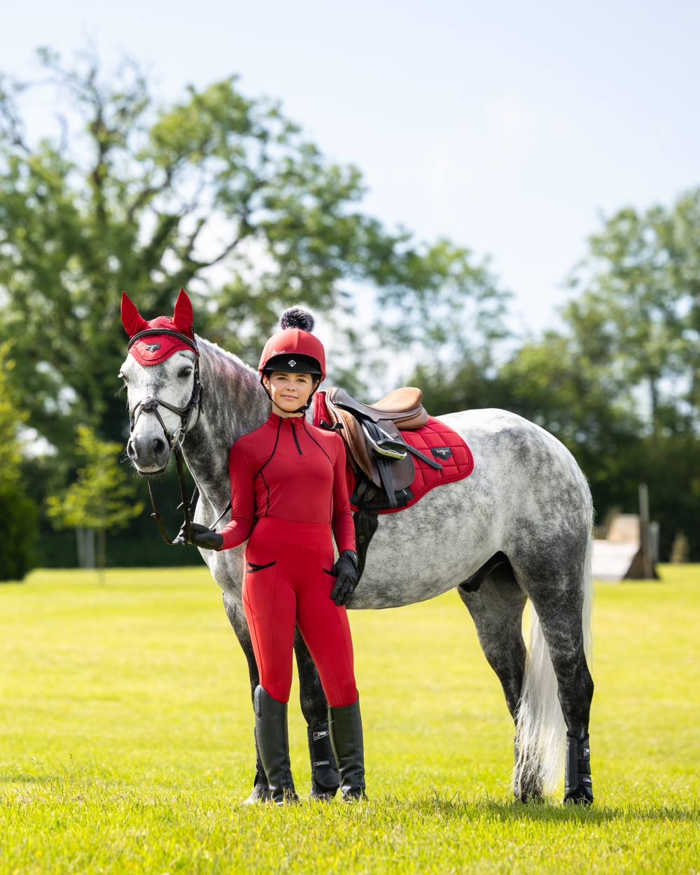 Chilli Coloured LeMieux Young Rider Pull On Breeches On A Riding Arena Background 