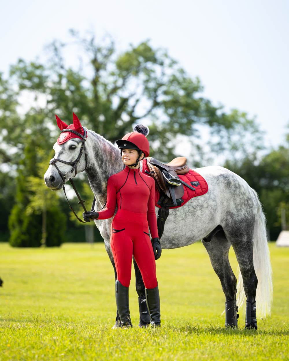 Chilli Coloured LeMieux Young Rider Pull On Breeches On A Riding Arena Background 