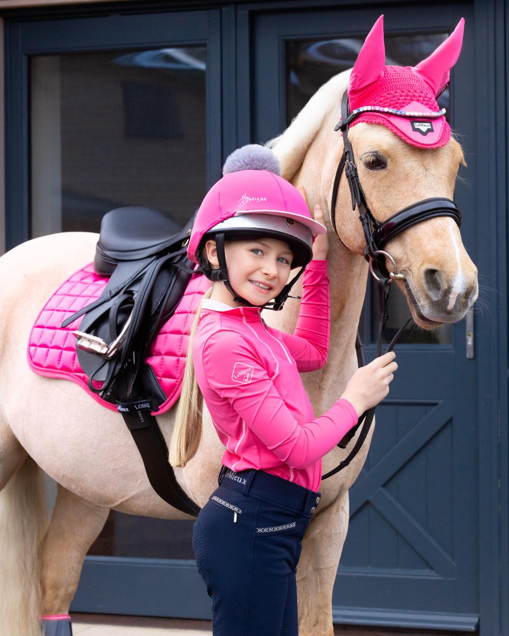 Indigo coloured LeMieux Young Rider St Tropez Breech on blue door background 