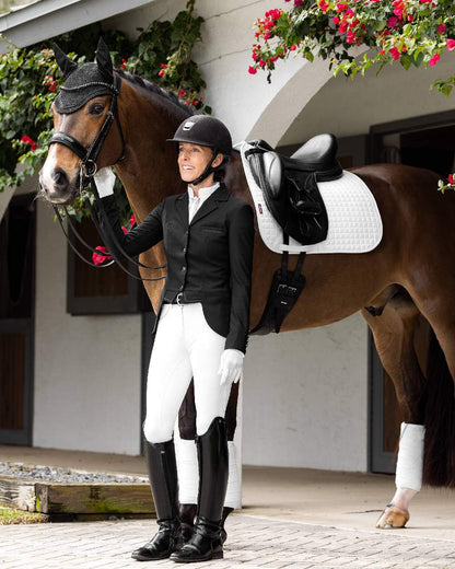 Black coloured LeMieux Zoe Show Jacket on white building background 