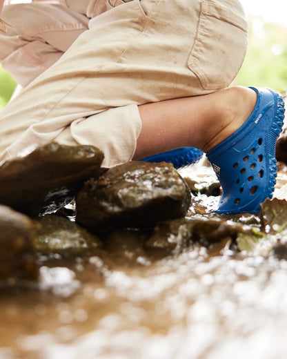 Blue Coloured Muck Boots Childrens Muckster Lite Clogs On A River Background 