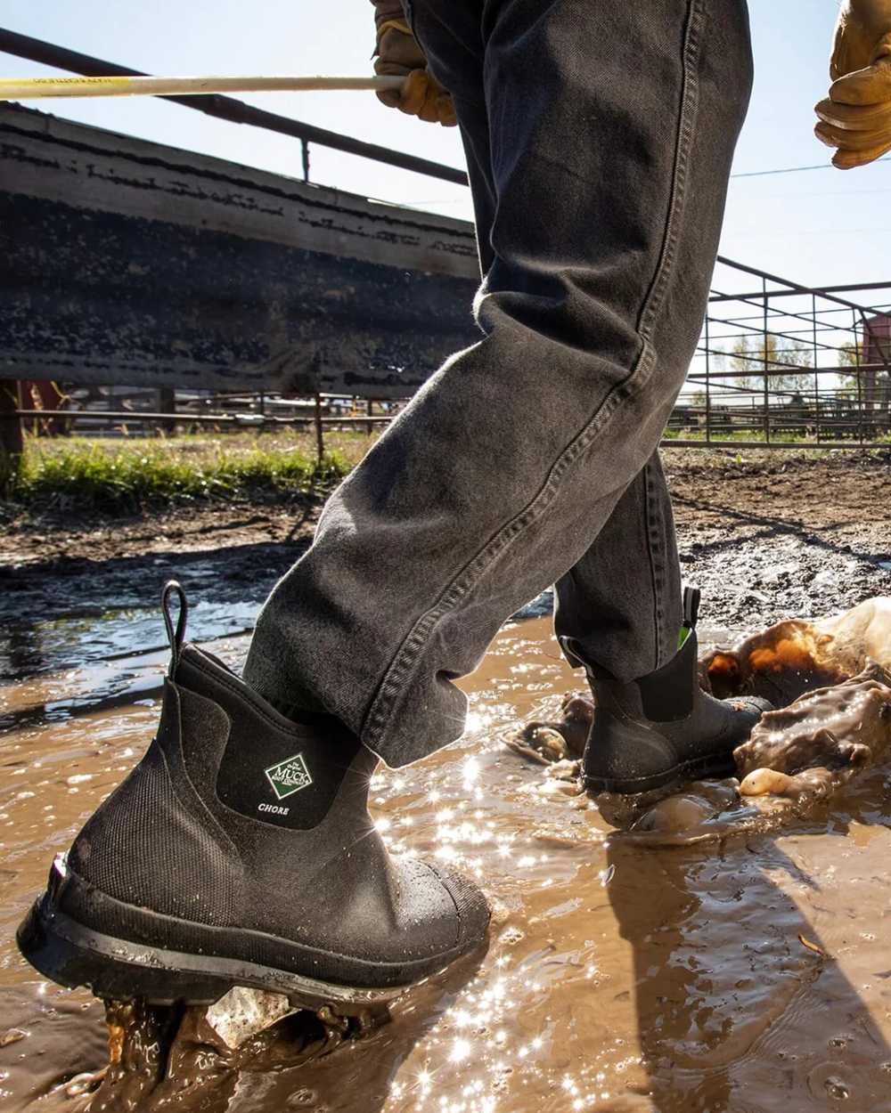 Black Coloured Muck Boots Chore Classic Chelsea Boots On A Farm Background