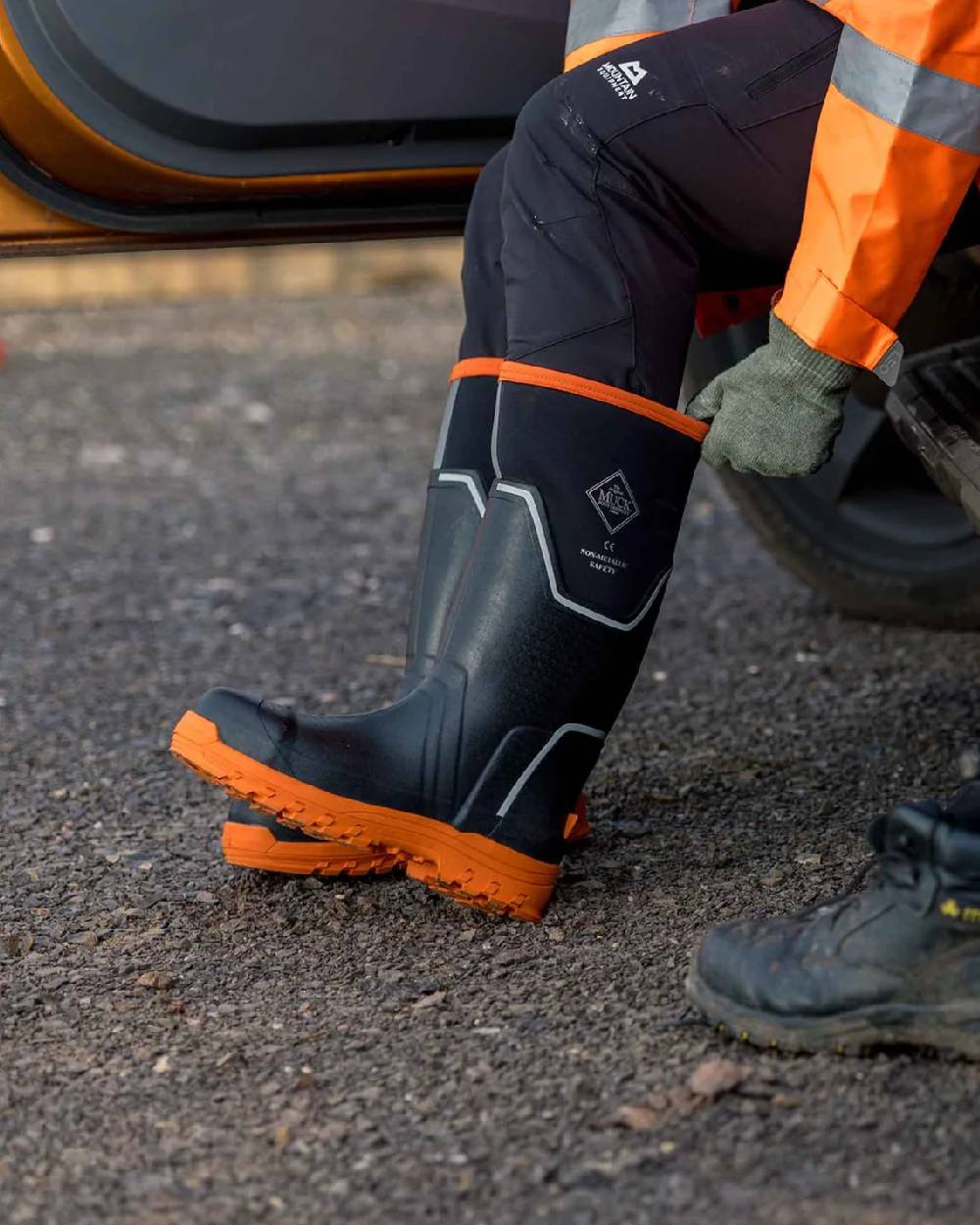 Black Orange Coloured Muck Boots Mens Grit S5 Tall Boots on Outdoor Background
